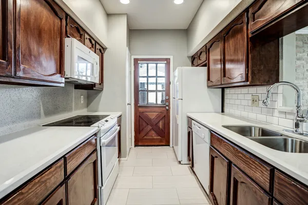 a kitchen that has a sink and a stove