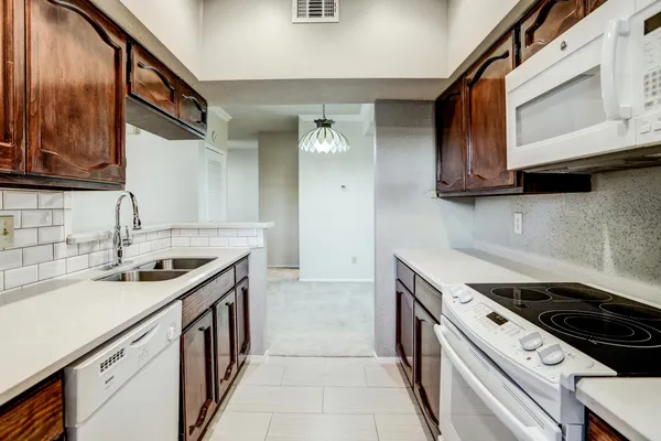 a kitchen with a sink stove and cabinets