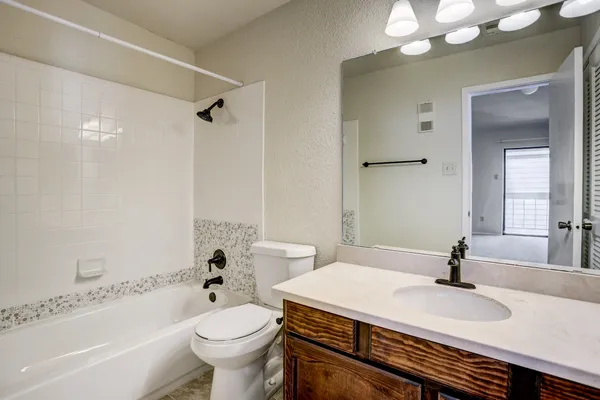 a bathroom with a sink a toilet and a bathtub