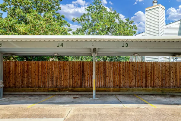 a wooden bench sitting in front of a building