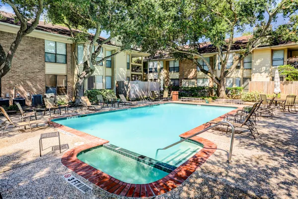 a view of a swimming pool with lounge chairs