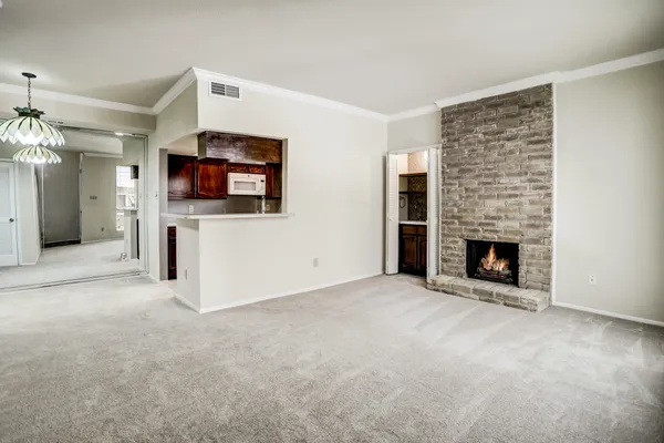 an empty room with furniture and a fireplace