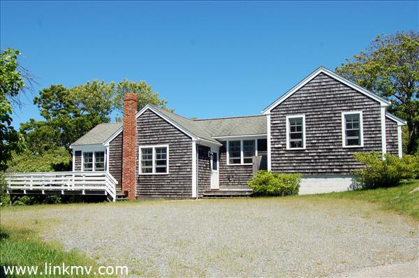 25 Basin Road Chilmark, MA 02535 - Photo 3 of 11 a front view of a house with a yard and garage