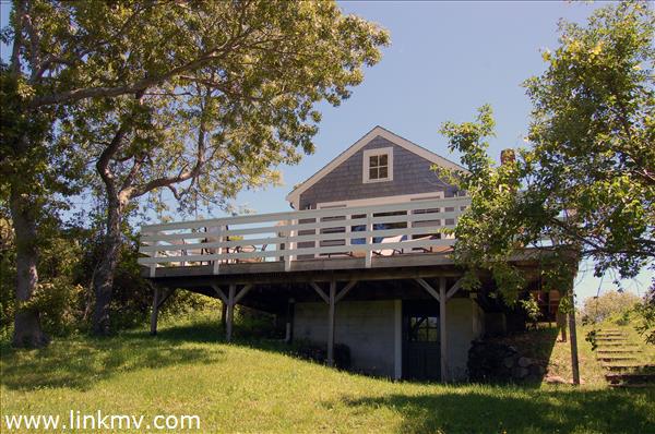 25 Basin Road Chilmark, MA 02535 - Photo 4 of 11 a front view of a house with a garden