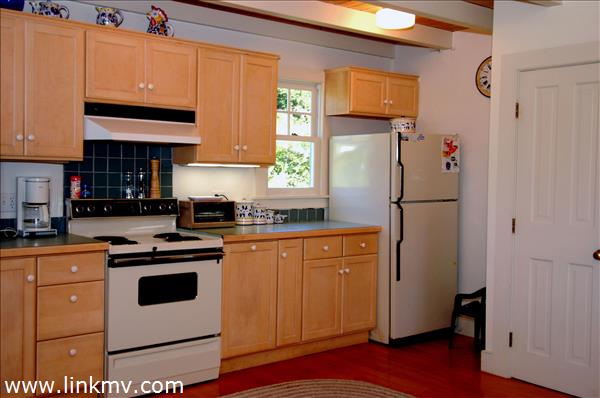 25 Basin Road Chilmark, MA 02535 - Photo 7 of 11 a kitchen with stainless steel appliances a refrigerator sink and cabinets