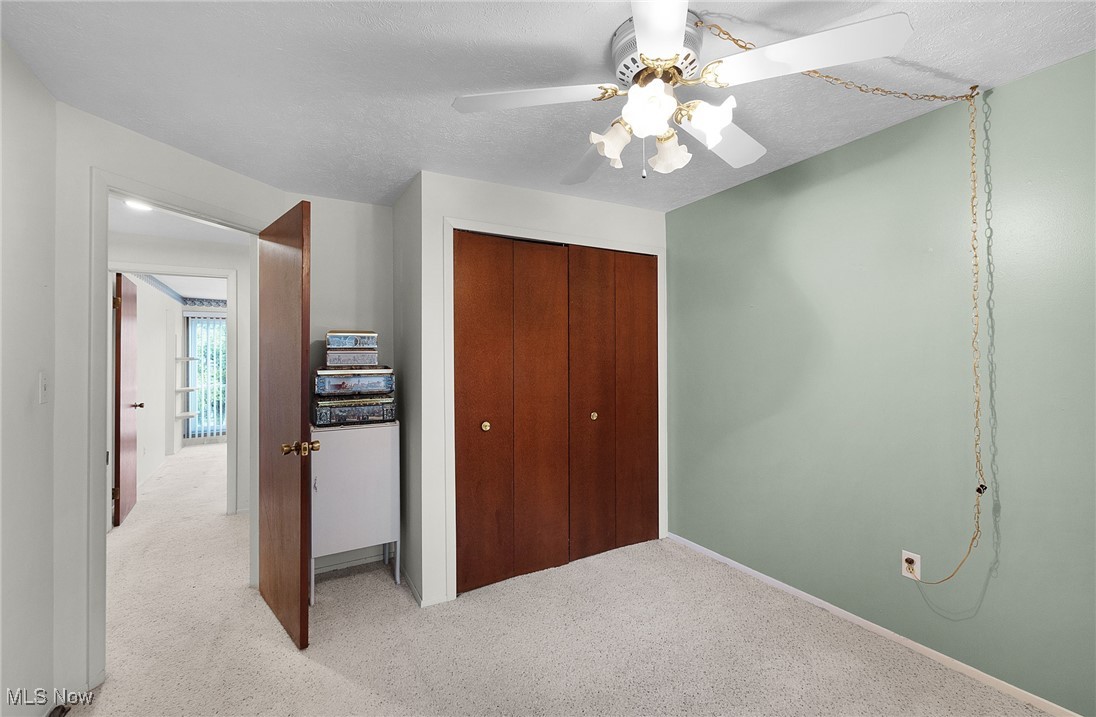 6474 State Road, Unit I10 Parma, OH 44134 - Photo 23 of 31 Unfurnished bedroom with carpet floors, a ceiling fan, a textured ceiling, and a closet