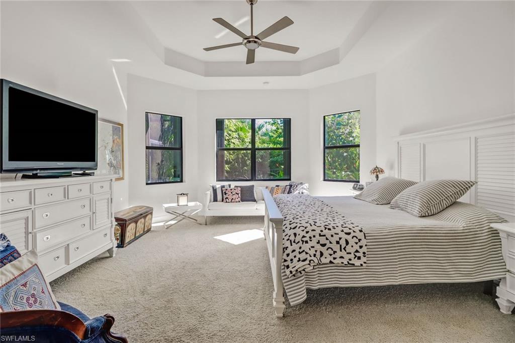 4617 Azalea Drive Naples, FL 34119 - Photo 14 of 34 a bedroom with a bed and a flat screen tv