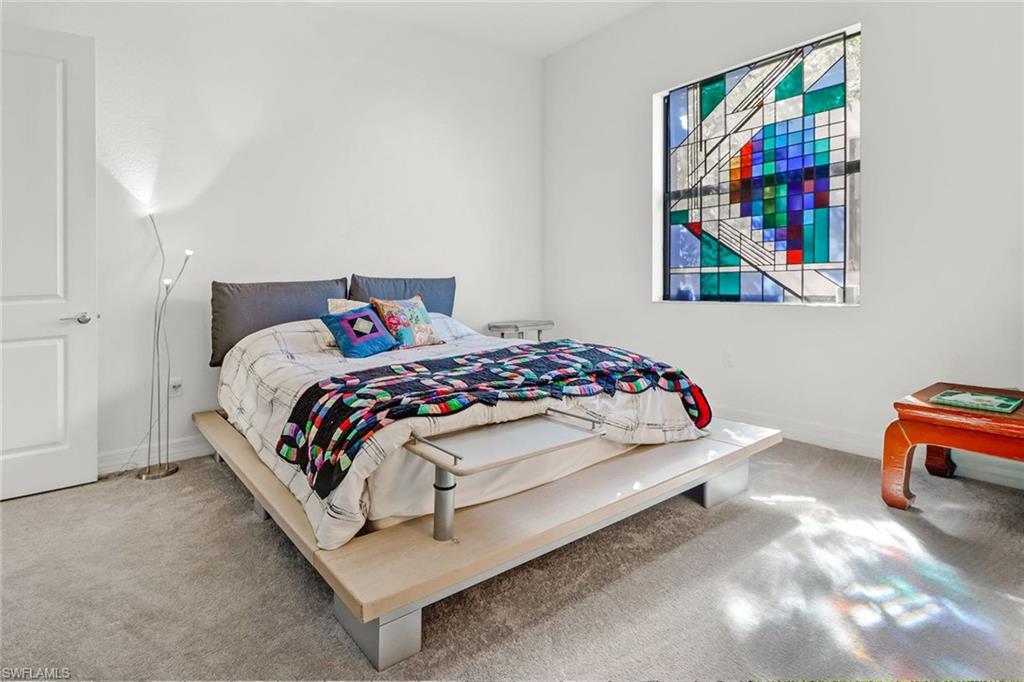 4617 Azalea Drive Naples, FL 34119 - Photo 17 of 34 a bedroom with a bed and a painting on the wall