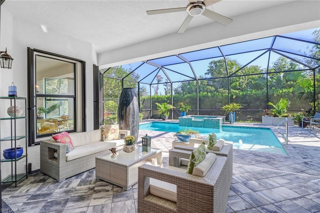 4617 Azalea Drive Naples, FL 34119 - Photo 21 of 34 a living room with patio furniture and a yard