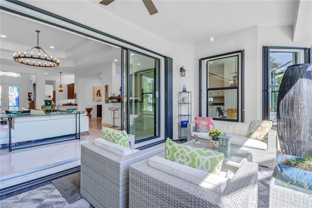 4617 Azalea Drive Naples, FL 34119 - Photo 22 of 34 a living room with furniture and a chandelier