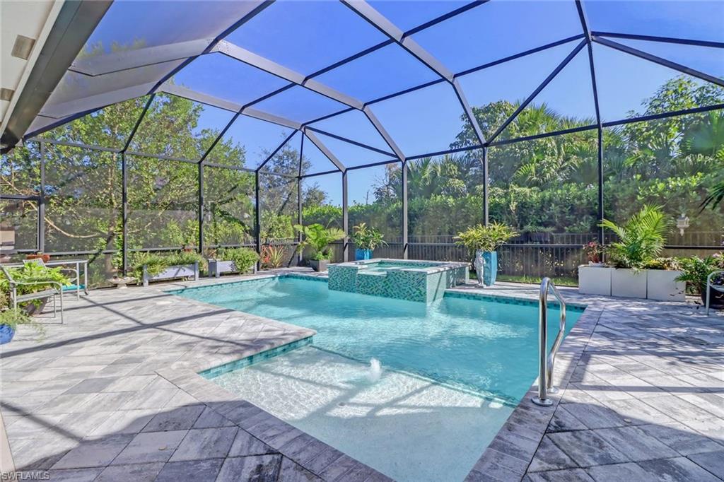 4617 Azalea Drive Naples, FL 34119 - Photo 3 of 34 a view of a yard with a table and chairs under an umbrella
