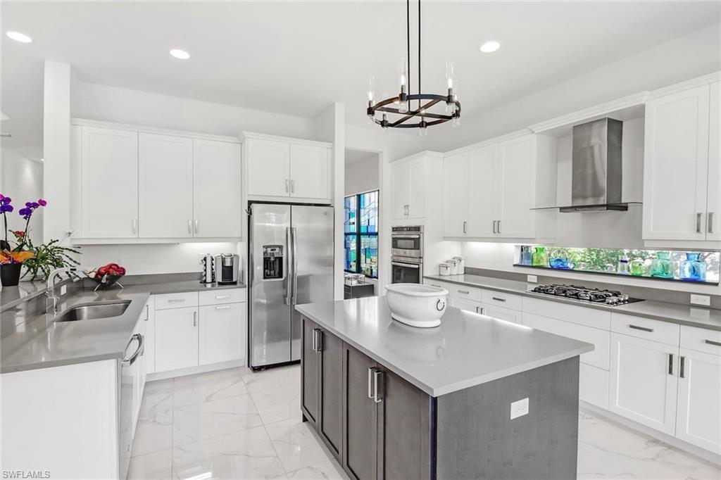 4617 Azalea Drive Naples, FL 34119 - Photo 8 of 34 a kitchen with a center island appliances and cabinets