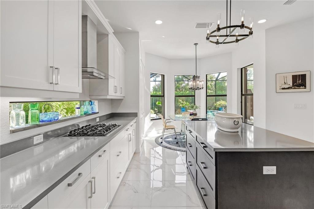 4617 Azalea Drive Naples, FL 34119 - Photo 9 of 34 a kitchen with stainless steel appliances granite countertop a sink stove and cabinets