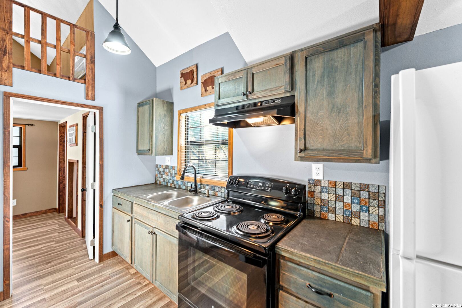 297 Chaparral Drive Bandera, TX 78003 - Photo 7 of 19 a kitchen with stainless steel appliances granite countertop a stove and a refrigerator