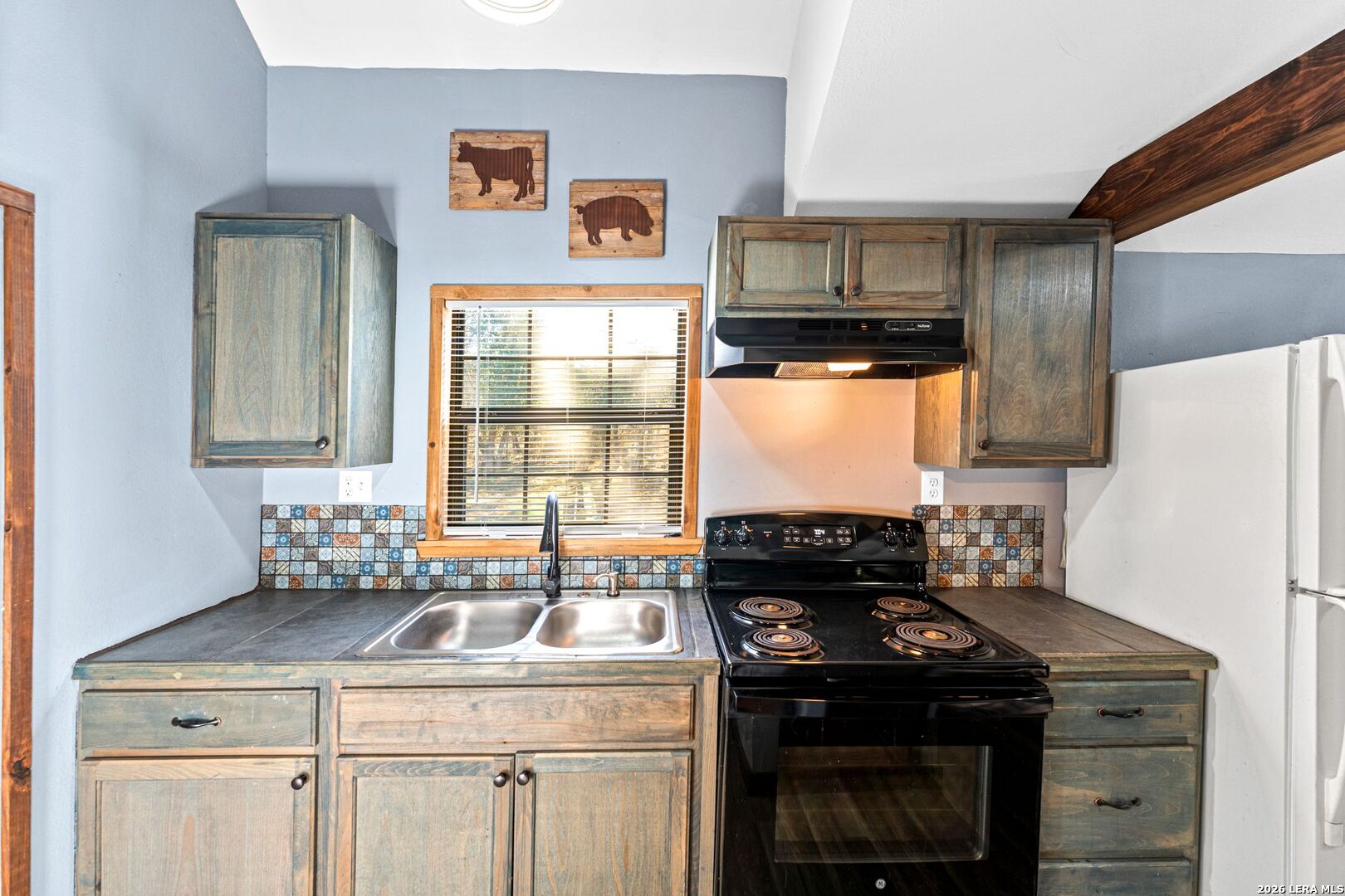 297 Chaparral Drive Bandera, TX 78003 - Photo 8 of 19 a kitchen with a stove and a refrigerator