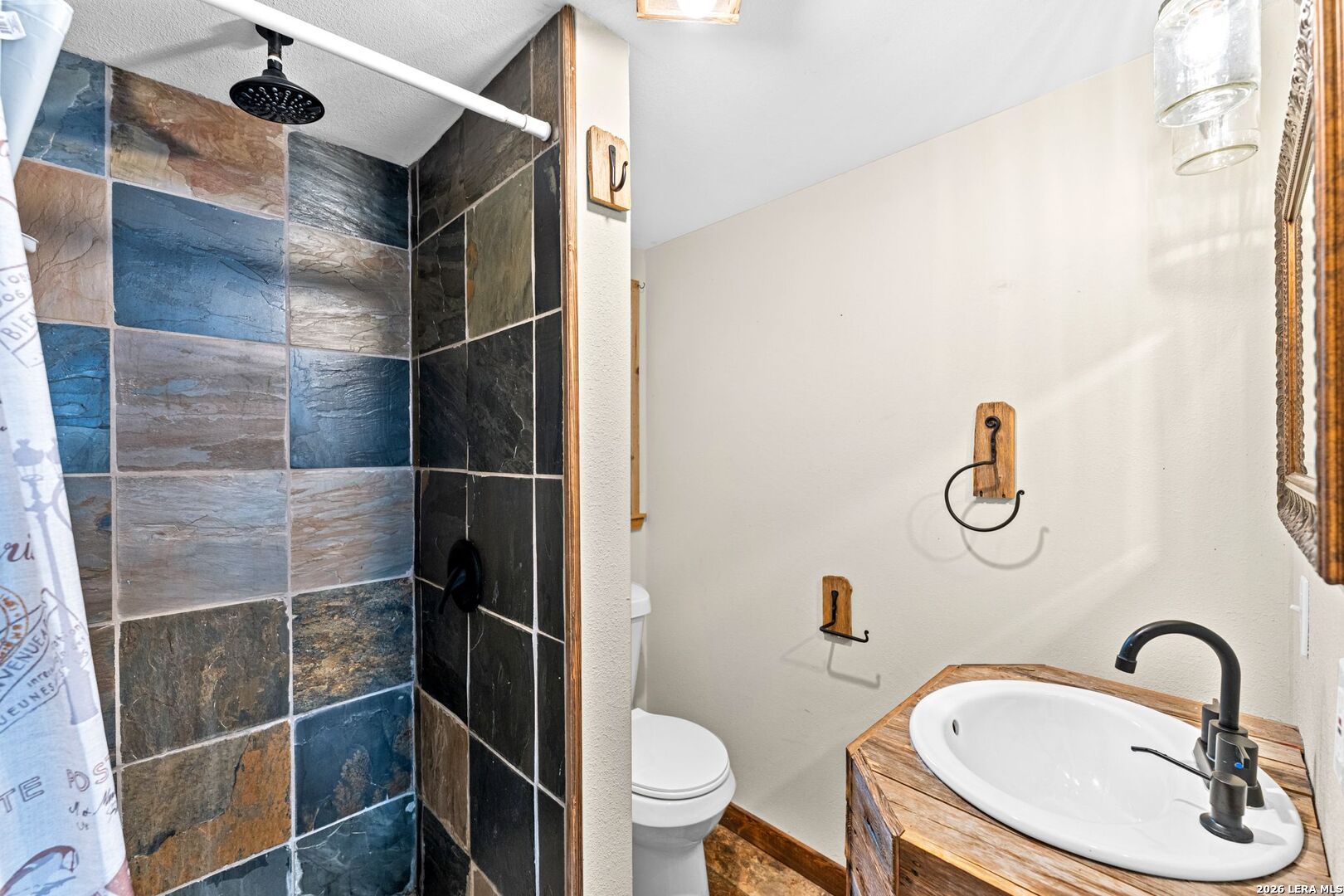 297 Chaparral Drive Bandera, TX 78003 - Photo 10 of 19 a bathroom with a sink toilet and shower