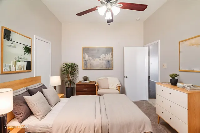 a bedroom with a large bed and a chandelier