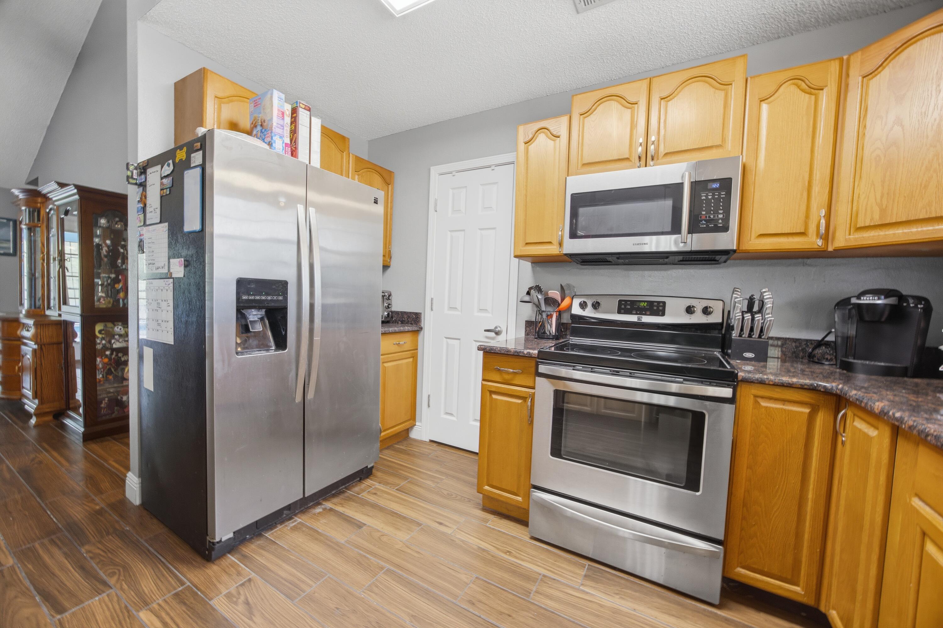 3494 Highway 90 Crestview, FL 32539 - Photo 14 of 71 a kitchen with stainless steel appliances granite countertop a stove a refrigerator and a microwave