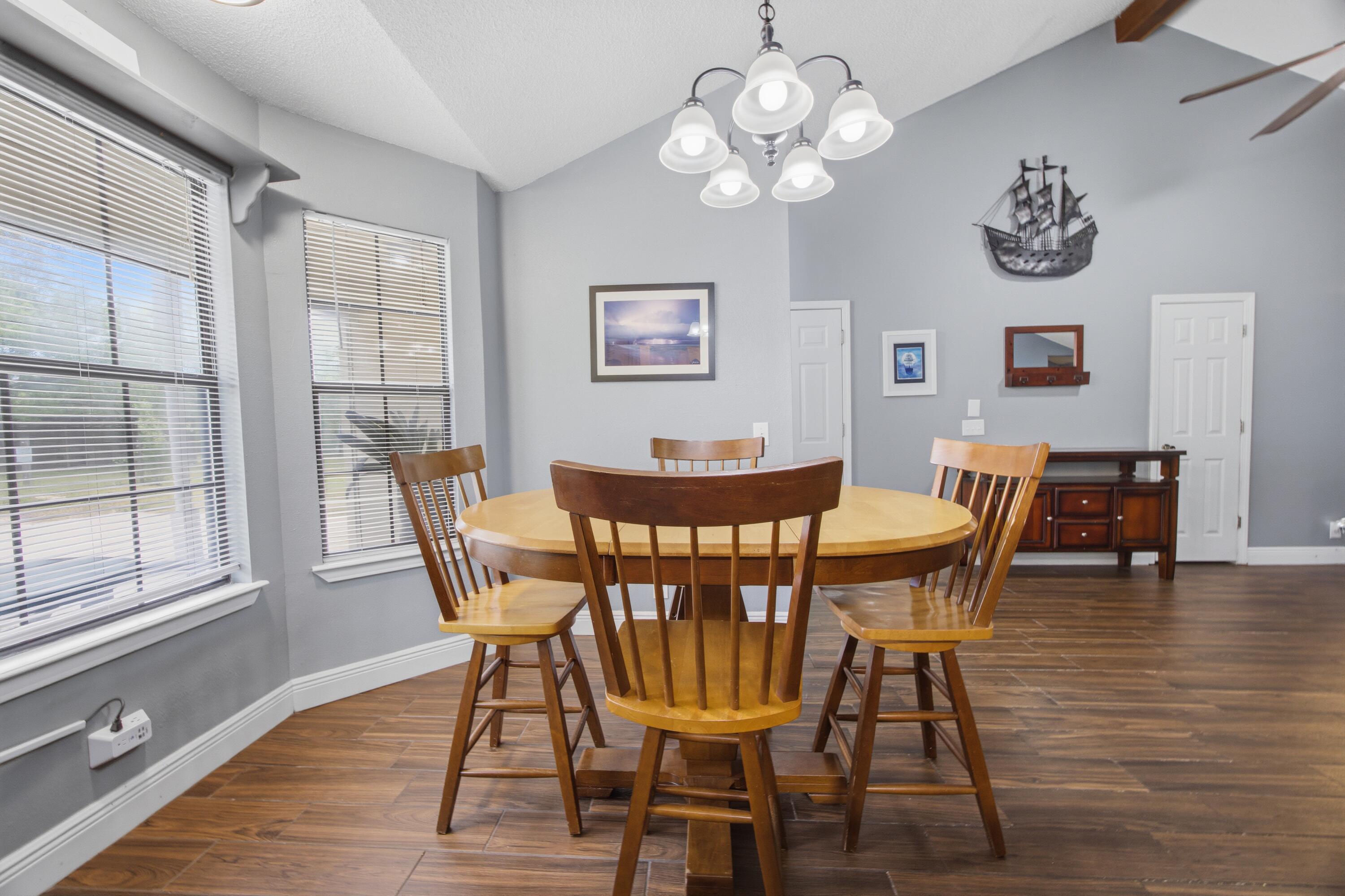 3494 Highway 90 Crestview, FL 32539 - Photo 15 of 71 a view of a dining room with furniture wooden floor and a chandelier
