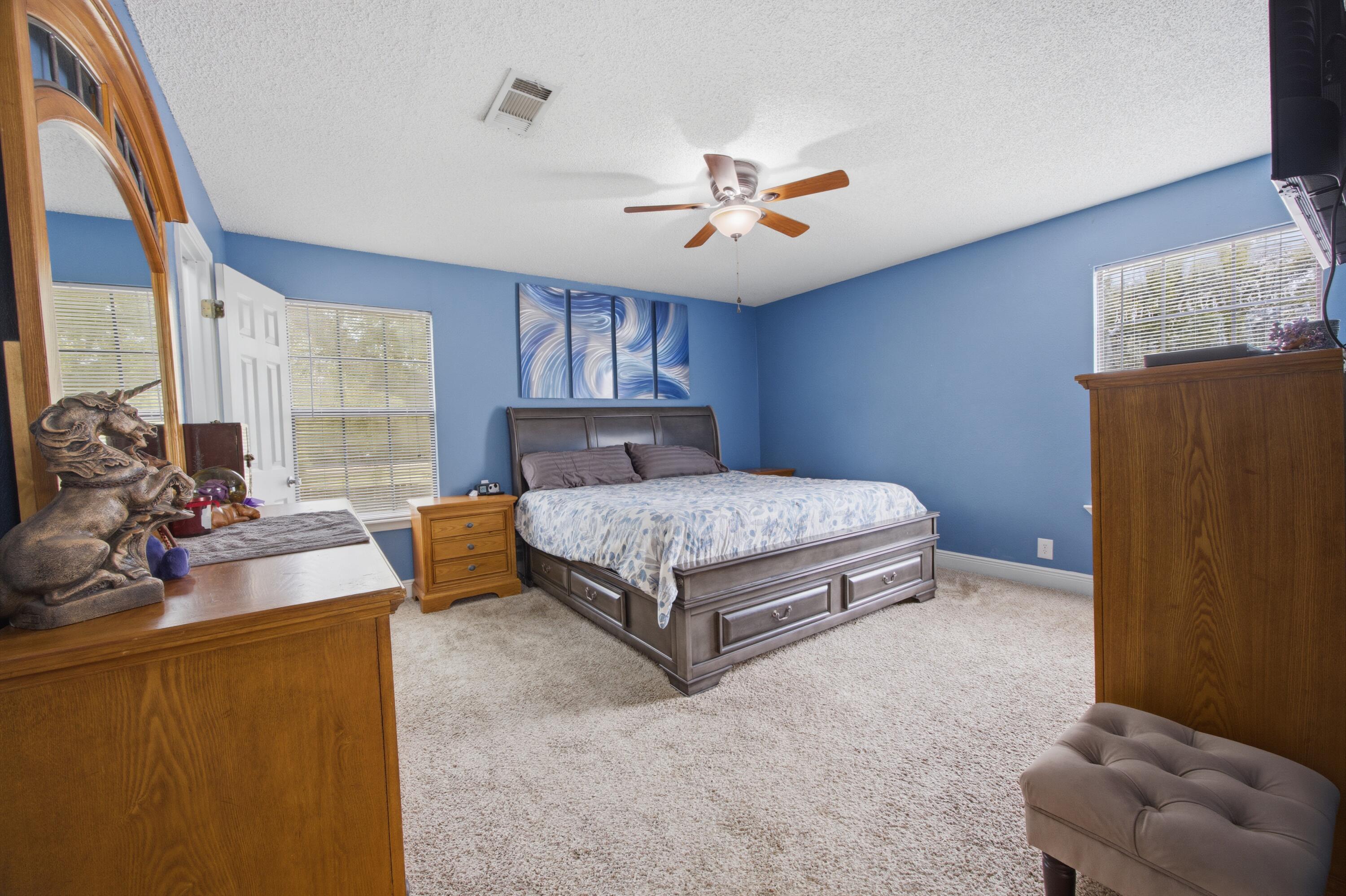3494 Highway 90 Crestview, FL 32539 - Photo 19 of 71 a bedroom with a bed couch chandelier and a window