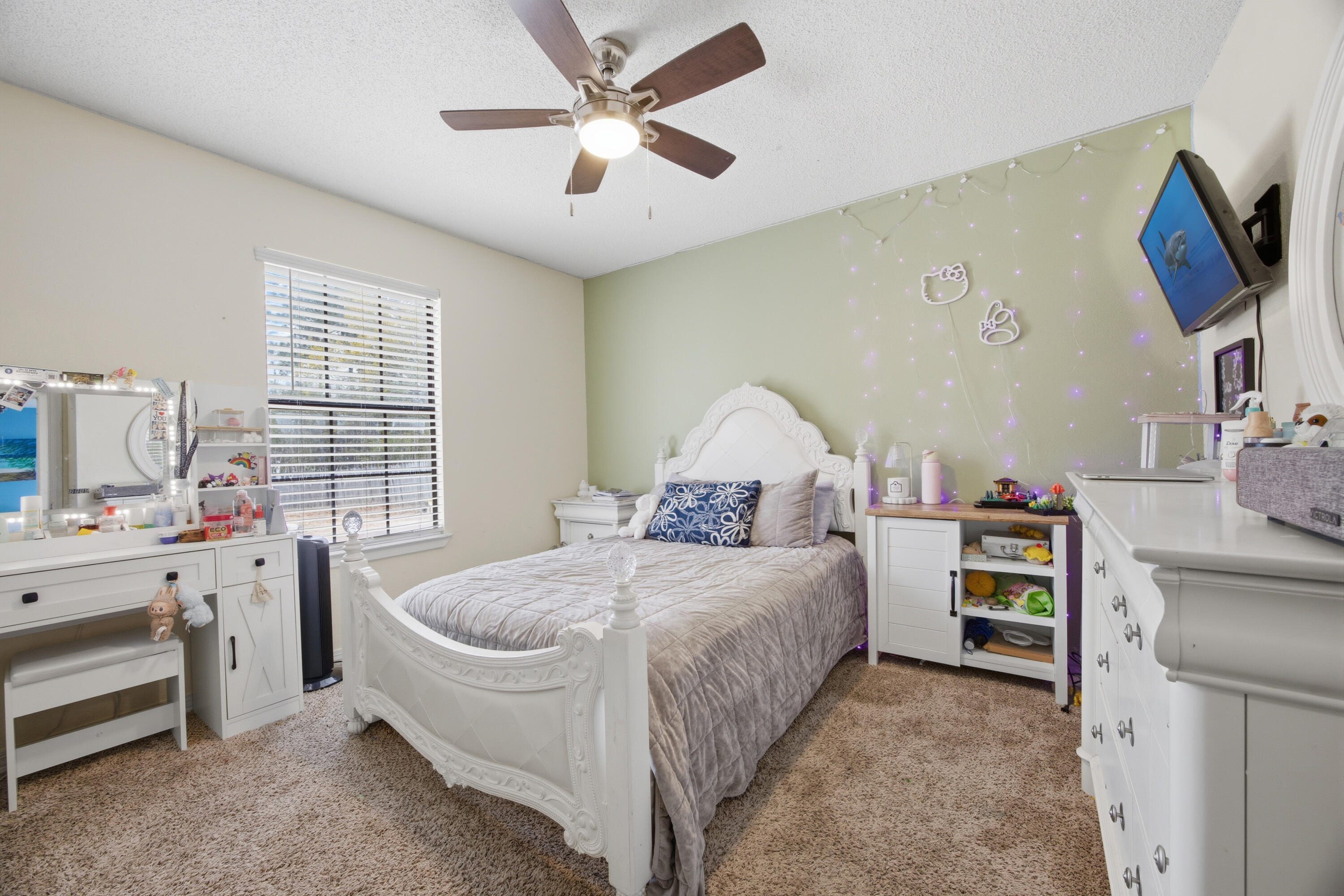 3494 Highway 90 Crestview, FL 32539 - Photo 40 of 71 a spacious bedroom with a bed and a chandelier