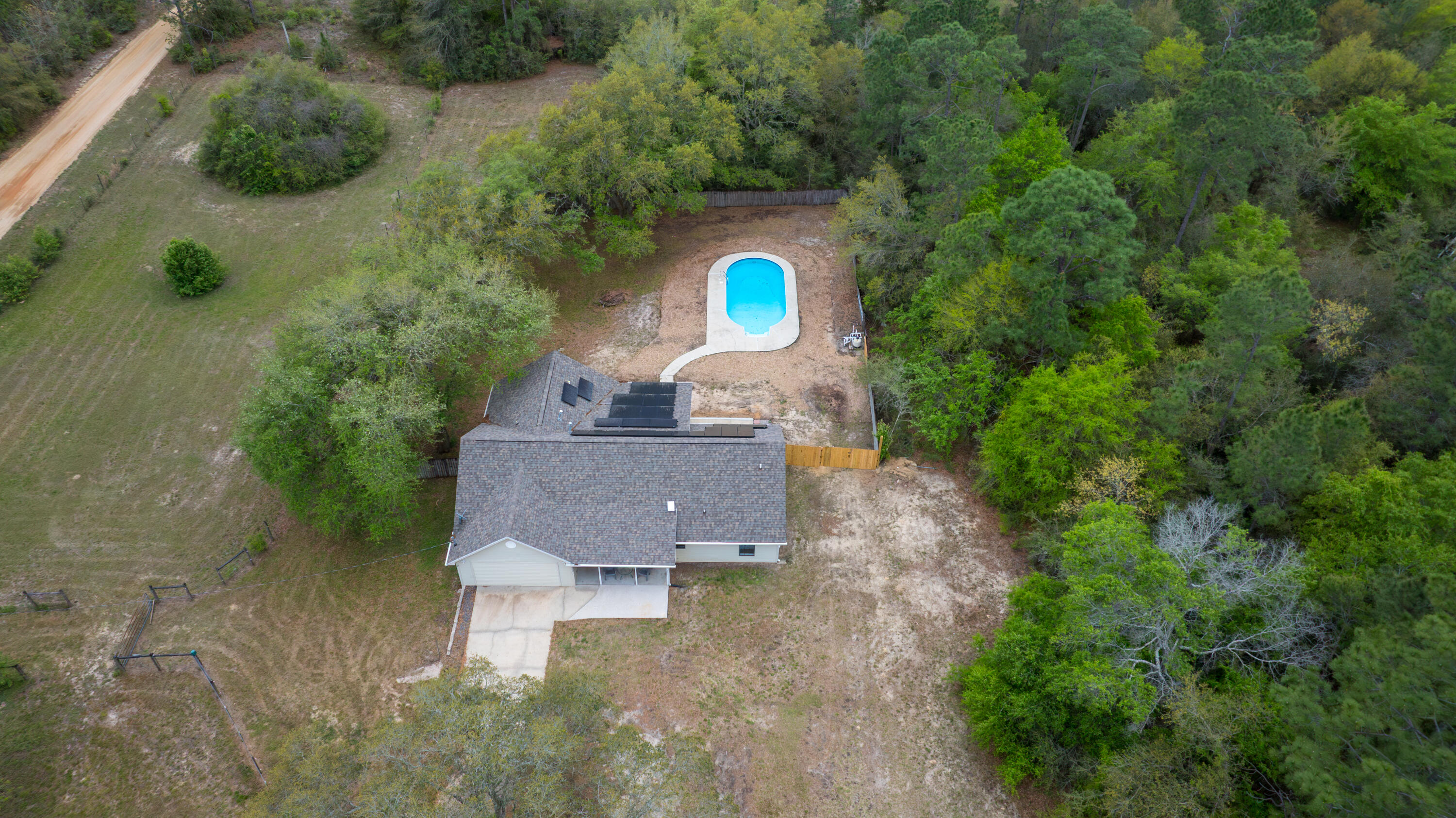 3494 Highway 90 Crestview, FL 32539 - Photo 4 of 71 an aerial view of a house with a yard and trees all around