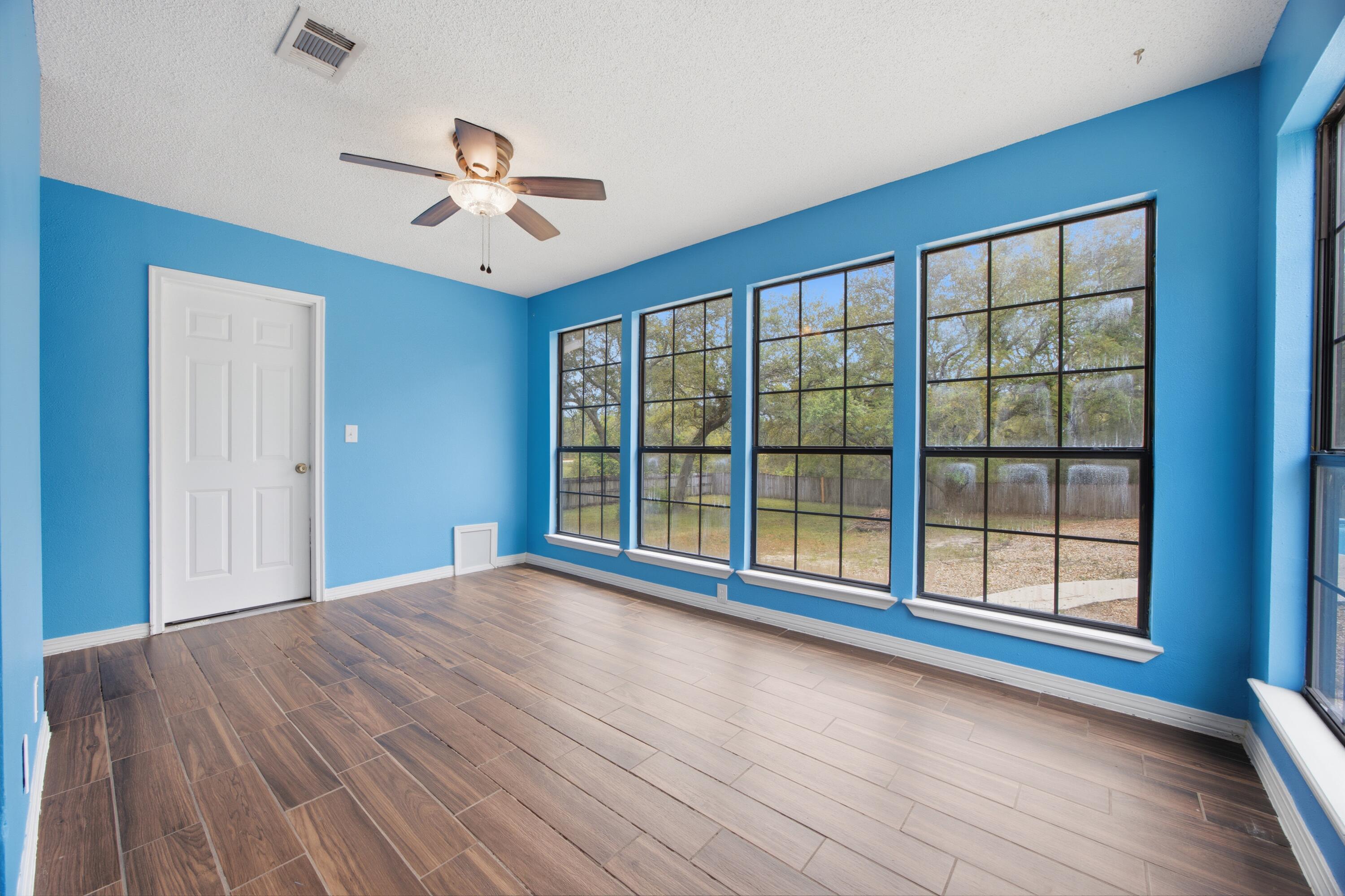 3494 Highway 90 Crestview, FL 32539 - Photo 46 of 71 a view of empty room with wooden floor and fan