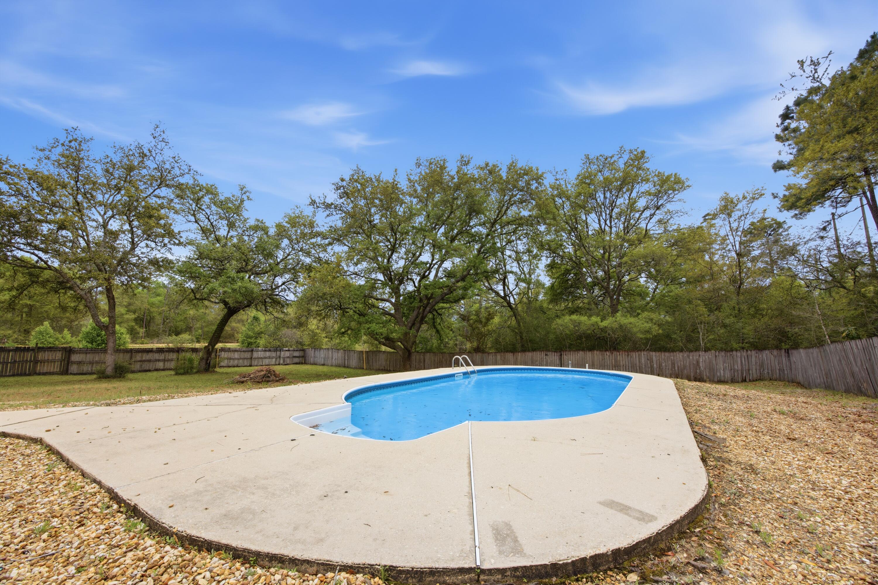 3494 Highway 90 Crestview, FL 32539 - Photo 58 of 71 a view of a swimming pool with an outdoor space and seating area