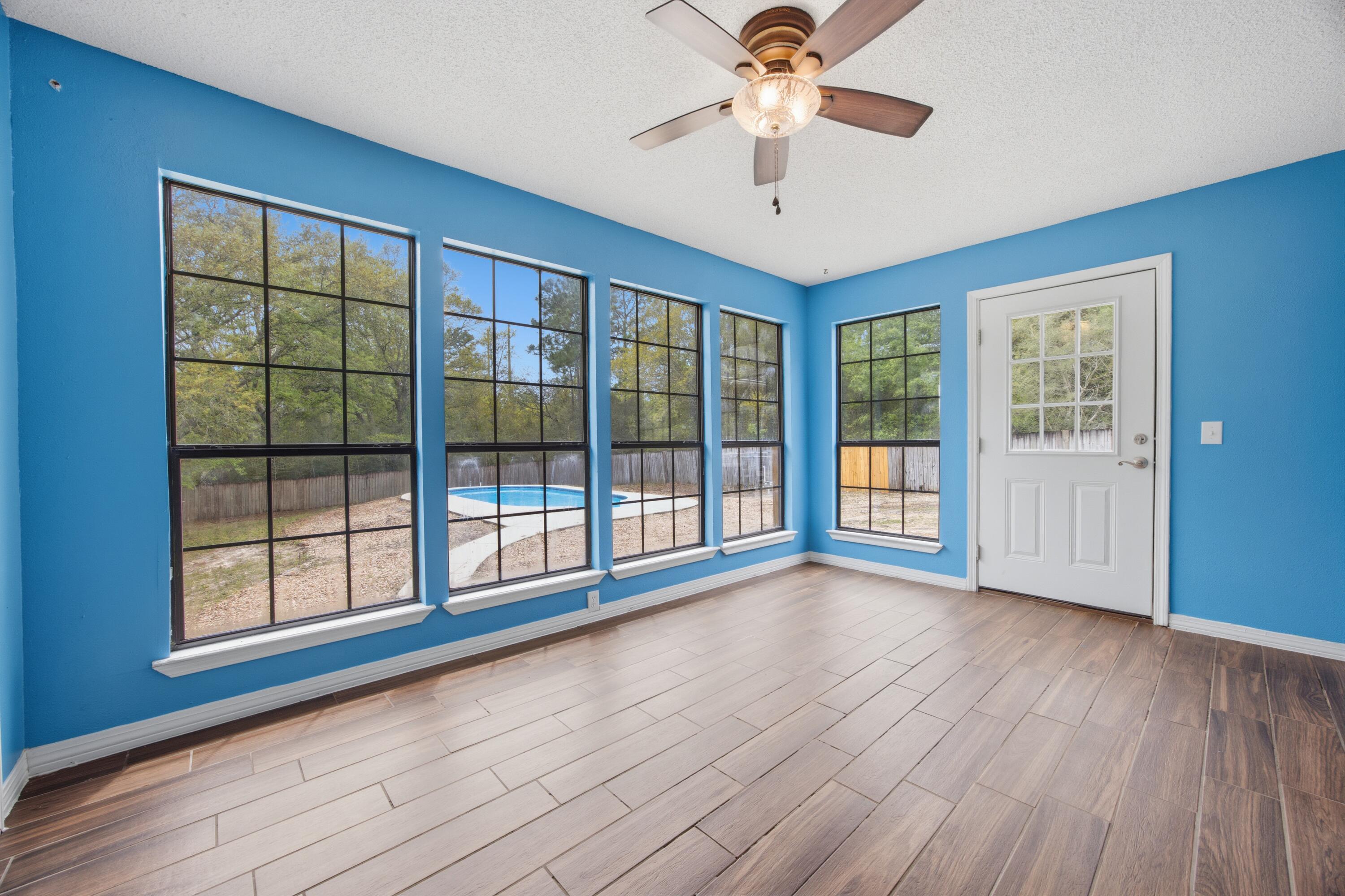 3494 Highway 90 Crestview, FL 32539 - Photo 7 of 71 a view of an empty room with a window and wooden floor