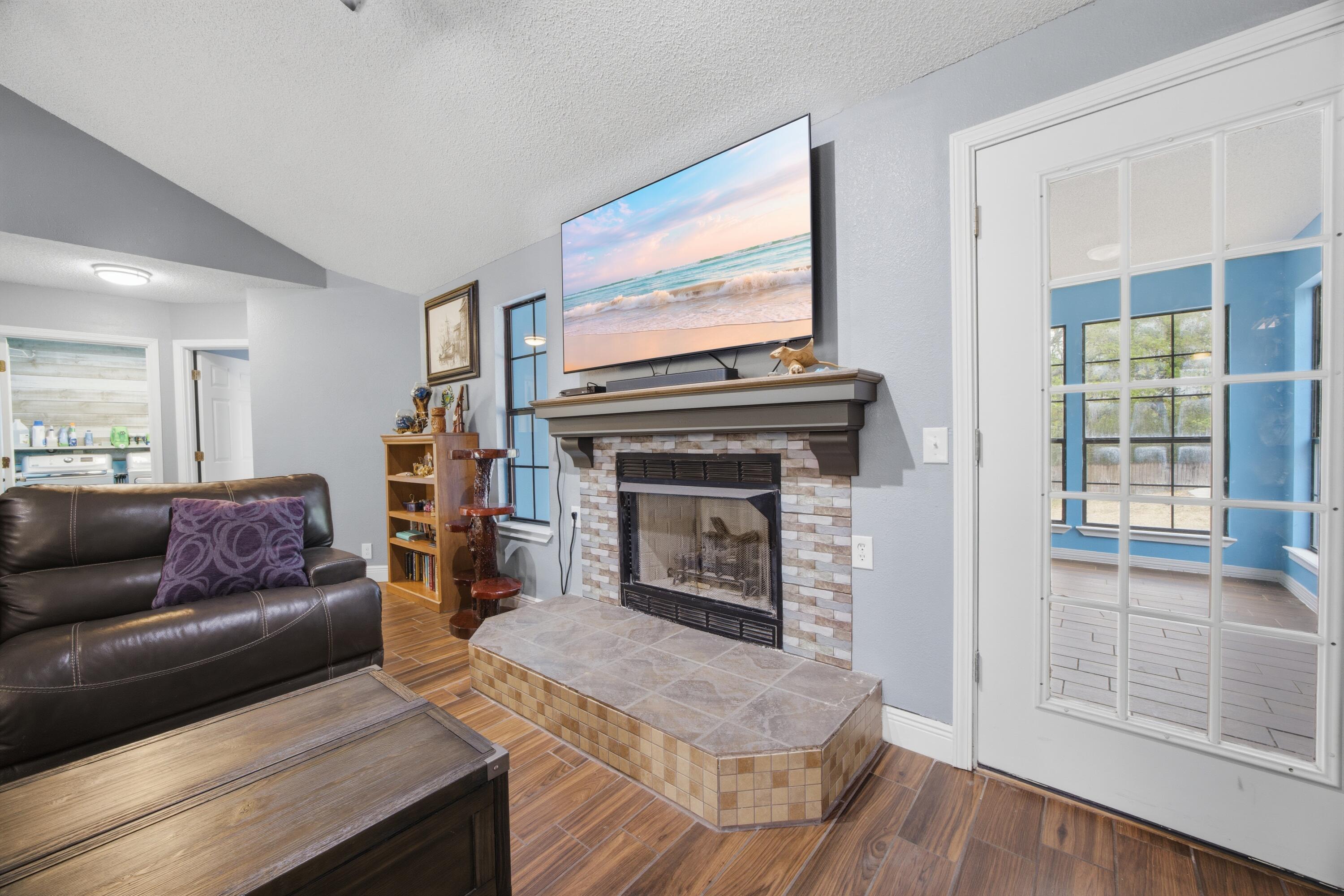 3494 Highway 90 Crestview, FL 32539 - Photo 10 of 71 a living room with furniture a flat screen tv and a fireplace