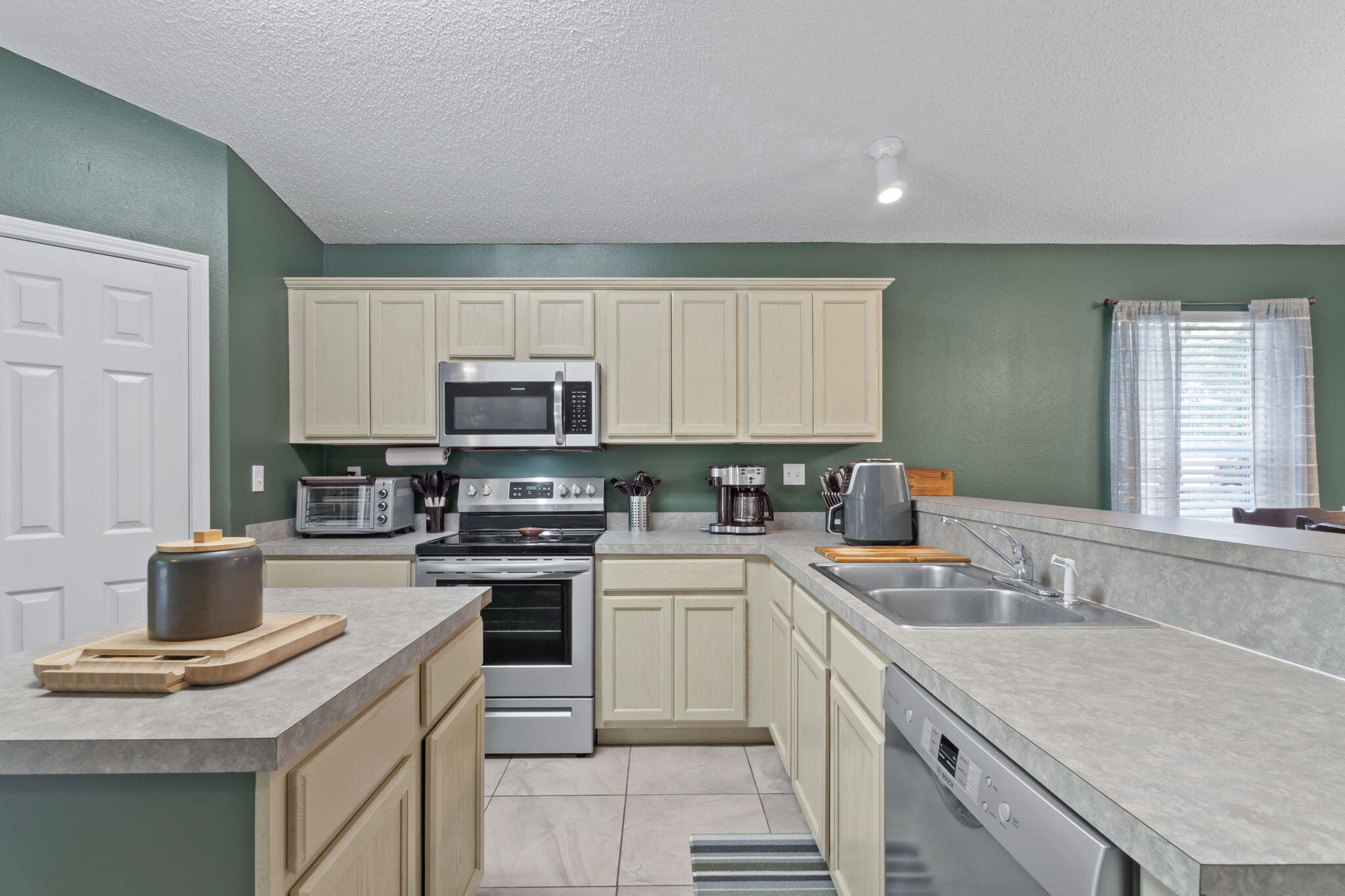 246 Limestone Circle Crestview, FL 32539 - Photo 11 of 27 a kitchen with a sink stove and cabinets