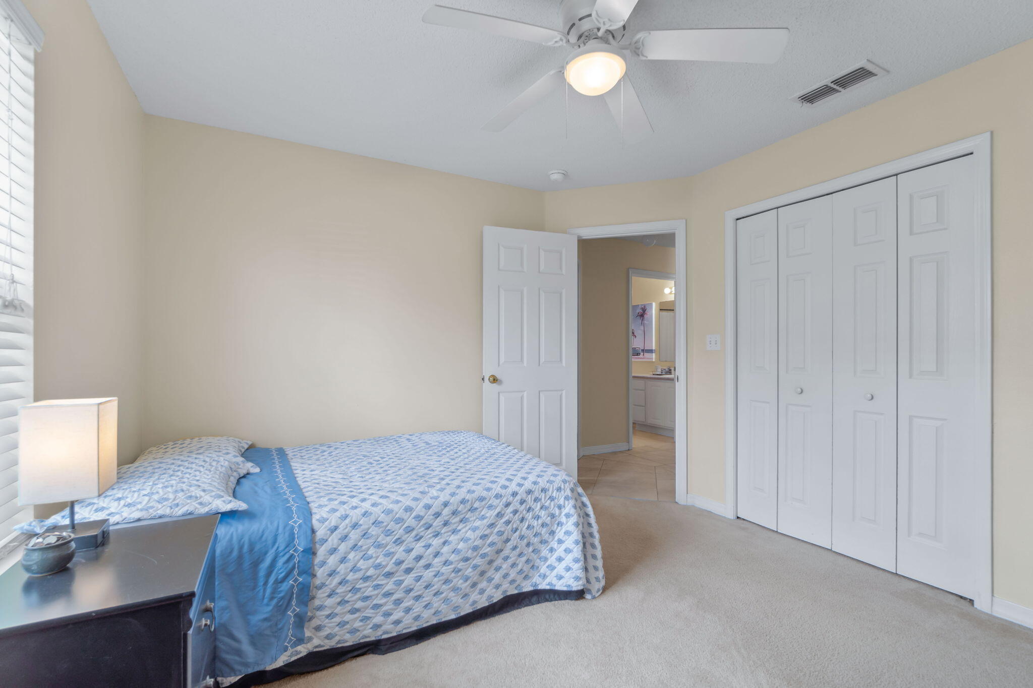 246 Limestone Circle Crestview, FL 32539 - Photo 14 of 27 a bedroom with a bed and a chandelier
