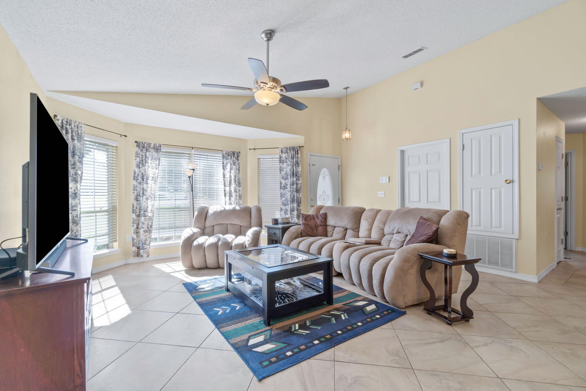 246 Limestone Circle Crestview, FL 32539 - Photo 5 of 27 a living room with furniture a flat screen tv and a large window