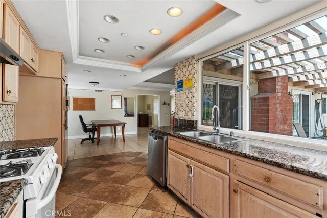 a open kitchen with granite countertop a sink and a stove