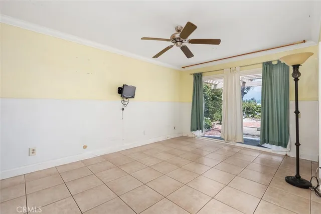 a view of a livingroom with a ceiling fan and window