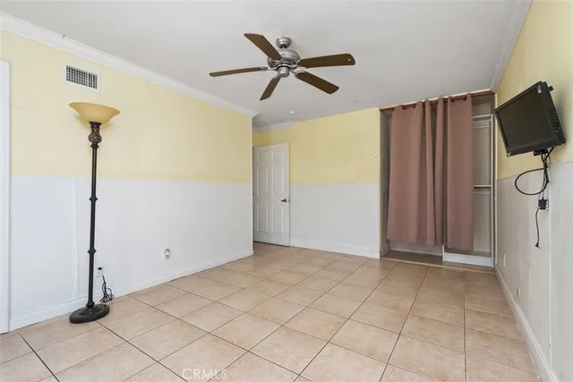 a view of a livingroom with wooden floor and a ceiling fan