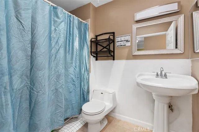 a bathroom with a sink toilet and mirror