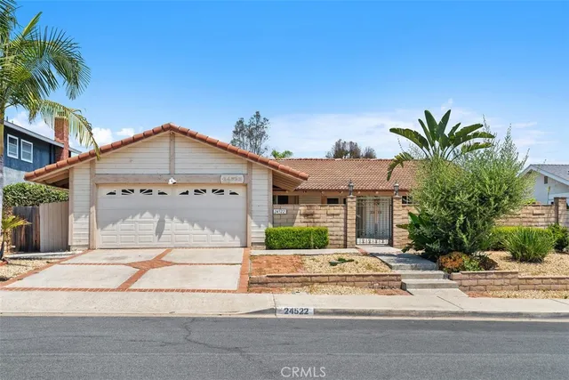 a view of a house with a yard and plants