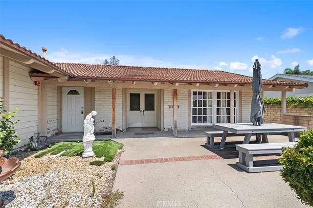 a front view of a house with garden and porch
