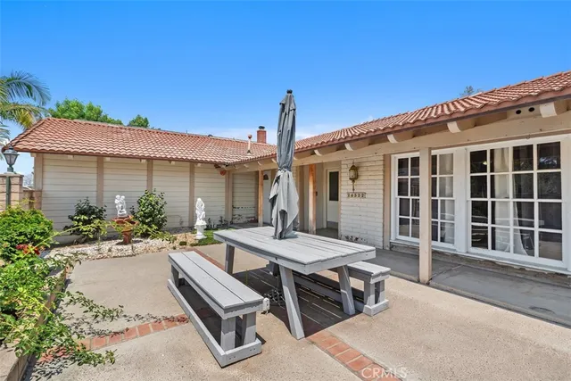 a view of a house with backyard sitting area and porch