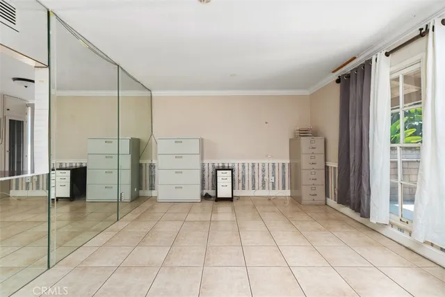 a view of a bedroom with furniture and windows