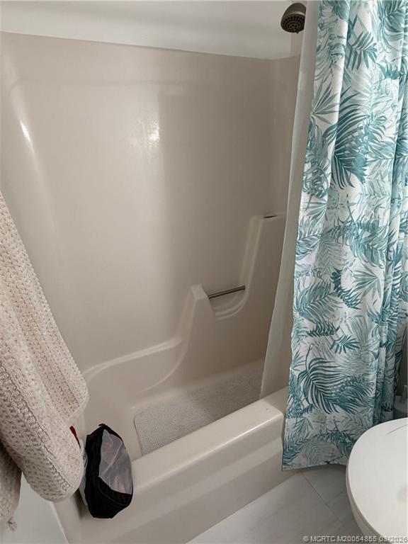 1225 Northwest 21st Street, Unit 7705 Stuart, FL 34994 - Photo 16 of 28 a bathroom with a bathtub and a shower