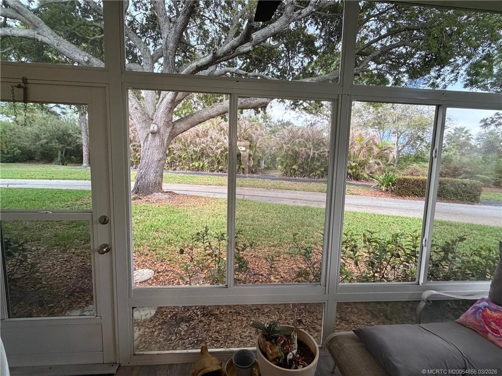 1225 Northwest 21st Street, Unit 7705 Stuart, FL 34994 - Photo 18 of 28 a view of a room with a large window and chairs