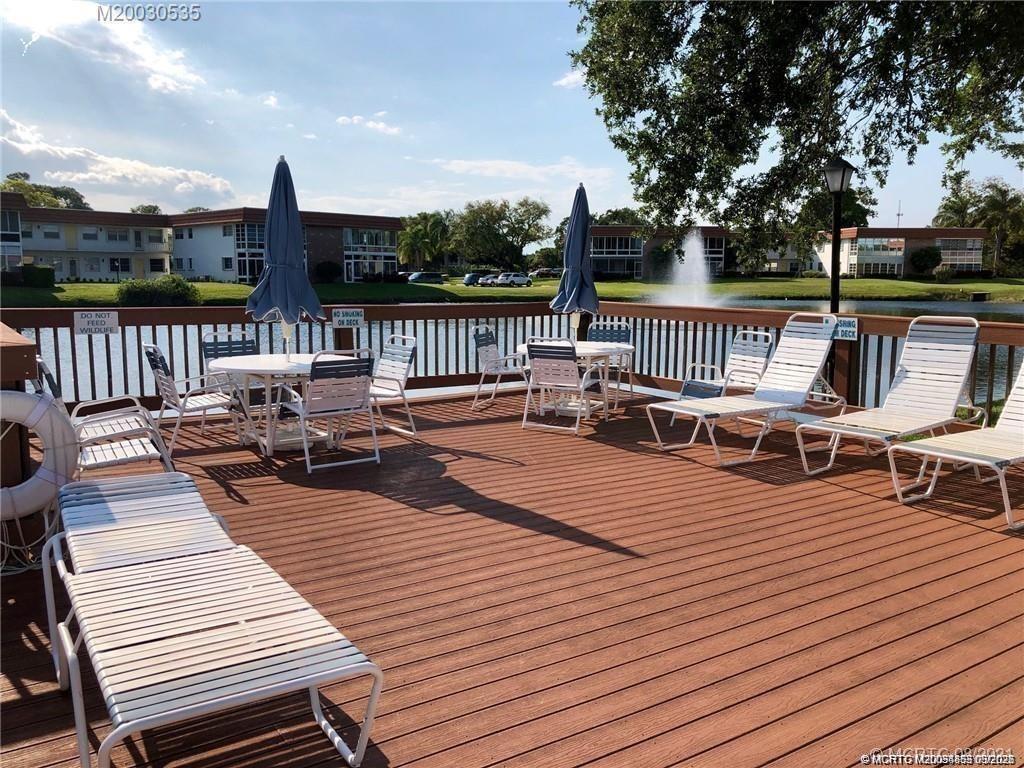 1225 Northwest 21st Street, Unit 7705 Stuart, FL 34994 - Photo 26 of 28 a view of a patio on wooden deck with city view