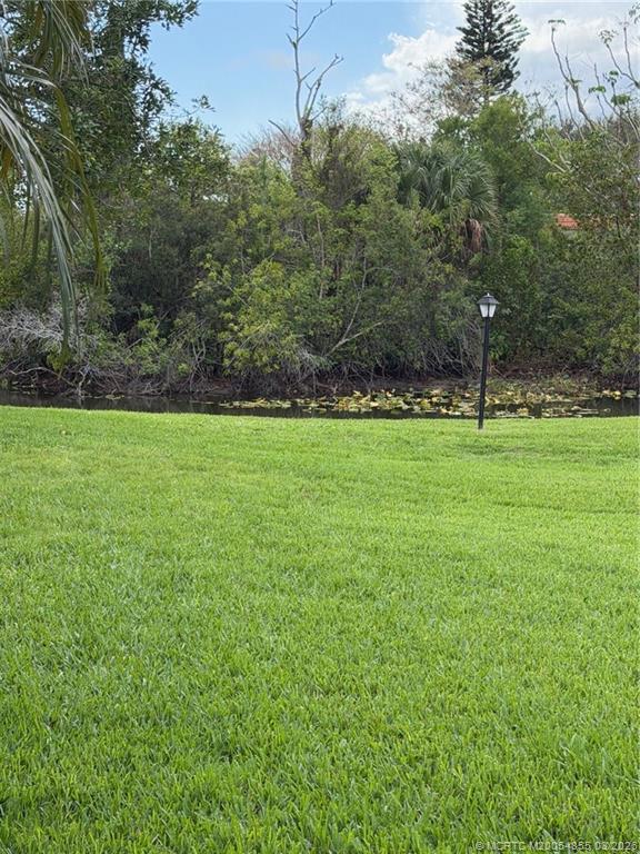 1225 Northwest 21st Street, Unit 7705 Stuart, FL 34994 - Photo 3 of 28 a view of a grassy field with trees