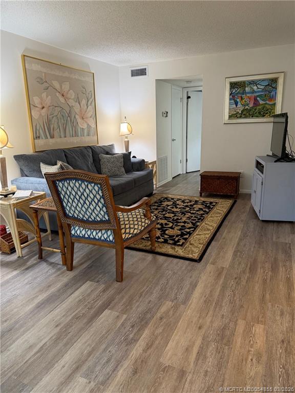 1225 Northwest 21st Street, Unit 7705 Stuart, FL 34994 - Photo 4 of 28 a living room with furniture and a rug
