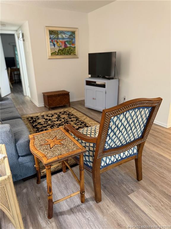 1225 Northwest 21st Street, Unit 7705 Stuart, FL 34994 - Photo 5 of 28 a outdoor sitting area with furniture and wooden floor