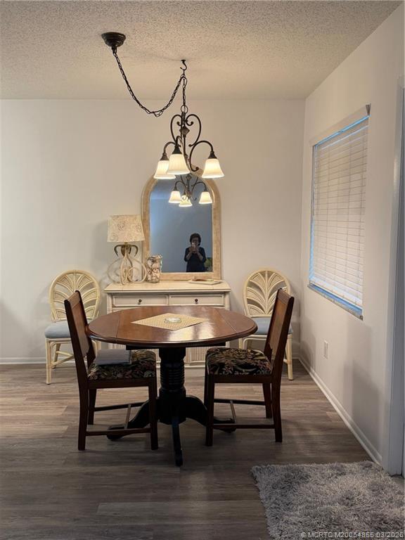 1225 Northwest 21st Street, Unit 7705 Stuart, FL 34994 - Photo 6 of 28 a view of a dining room with furniture and wooden floor