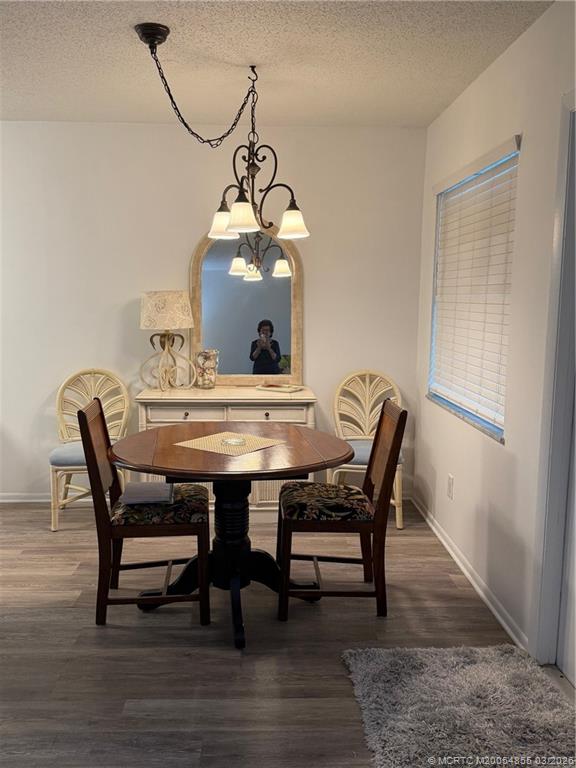 1225 Northwest 21st Street, Unit 7705 Stuart, FL 34994 - Photo 7 of 28 a view of a dining room with furniture and wooden floor