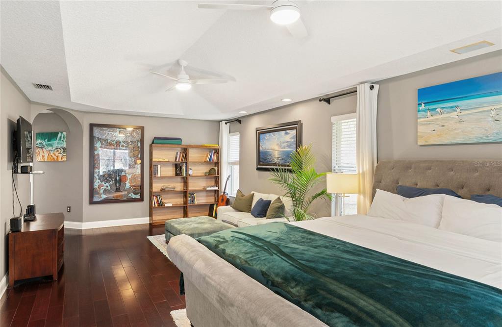 133 Ross Lake Lane Sanford, FL 32771 - Photo 15 of 32 a bedroom with a large bed and a flat tv screen on dresser